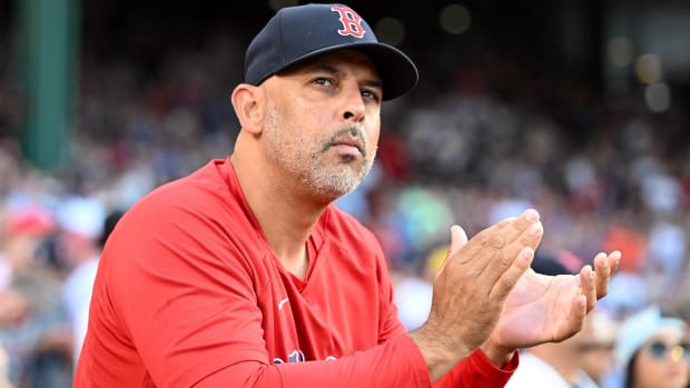 Red Sox manager Alex Cora claps his hands during a game.