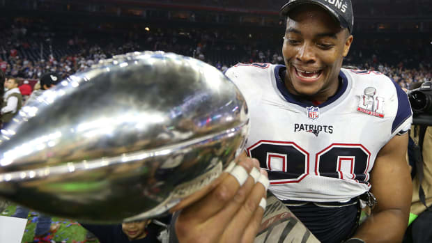 Patriots defensive end Trey Flowers (98) celebrates with the Vince Lombardi Trophy after beating the Falcons during Super Bowl LI at NRG Stadium.