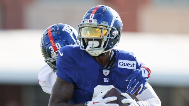 Aug 1, 2023; East Rutherford, NJ, USA; New York Giants wide receiver Parris Campbell (0) catches the ball in front of cornerback Darnay Holmes (30) during training camp at the Quest Diagnostics Training Facility.