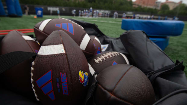 Kansas practice footballs are seen in an equipment bag at Monday's practice.  