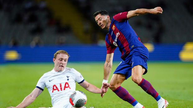 Oliver Skipp (left) and Robert Lewandowski pictured competing for the ball during Barcelona's 4-2 win over Tottenham in the 2023 Joan Gamper Trophy match