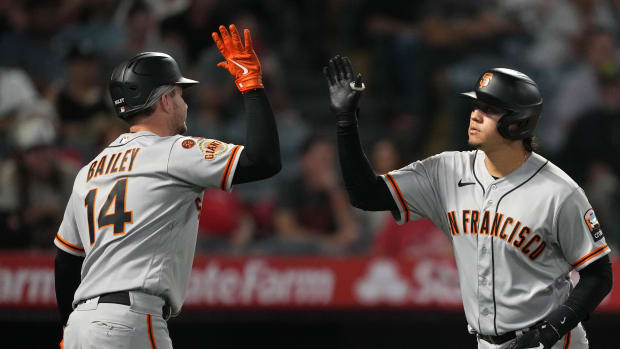 Patrick Bailey and Wilmer Flores celebrate getting 60% of the Giants' hits Tuesday in Anaheim