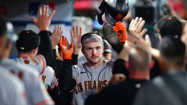SF Giants catcher Patrick Bailey (14) is greeted after scoring a run against the Los Angeles Angels (2023)