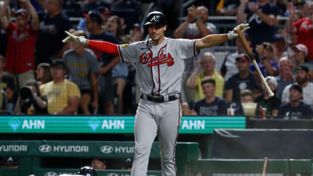 Aug 9, 2023; Pittsburgh, Pennsylvania, USA; Atlanta Braves first baseman Matt Olson (top) signals a safe call as center fielder Michael Harris II (23) scores a run against the Pittsburgh Pirates during the eighth inning at PNC Park.