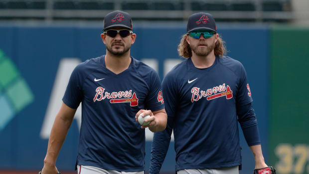 Aug 10, 2023; Pittsburgh, Pennsylvania, USA; Atlanta Braves relief pitchers Brad Hand (45) and Pierce Johnson (38) walk on the field before the game against at PNC Park.
