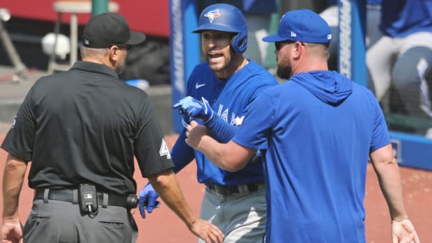 Blue Jays outfielder George Springer and manager John Schneider argue with an umpire after both were ejected.