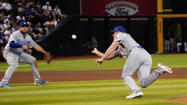 Dodgers’ Caleb Ferguson makes a diving catch.