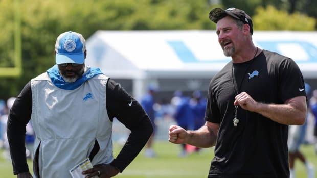 Detroit Lions Dan Campbell speaks with general manager Brad Holmes at training camp.