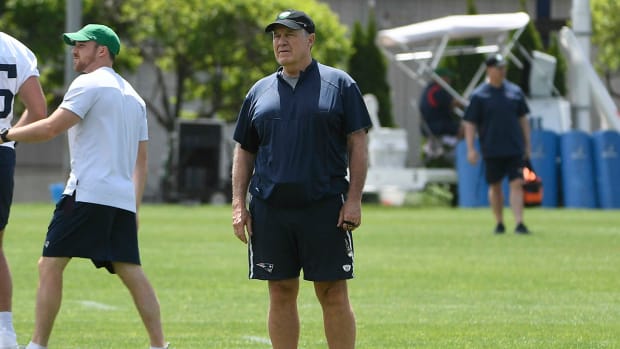 Patriots coach Bill Belichick watches players practice at the team’s OTAs.