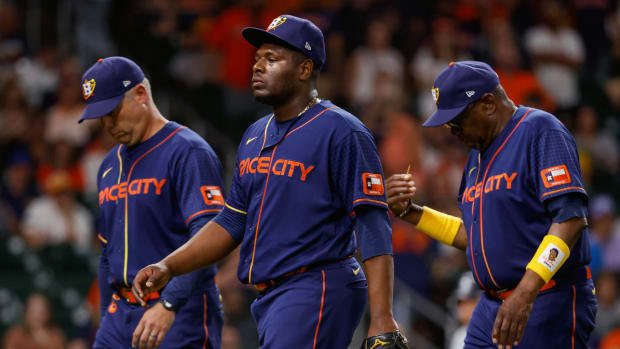 Houston Astros relief pitcher Hector Neris (50) and manager Dusty Baker Jr. (12) walk off the field after being ejected during the ninth inning against the Seattle Mariners.