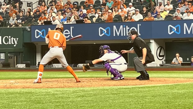 Trey Faltine of the University of Texas bats during the game versus Texas in the 2022 Big 12 Tournament. Umpire Casey Moser is behind the plate.