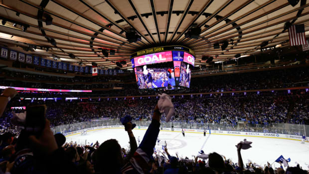 New York Rangers fans react after a goal by the New York Rangers against the Tampa Bay Lightning during the second period in Game 5 of the NHL Hockey Stanley Cup playoffs Eastern Conference Finals, Thursday, June 9, 2022, in New York (AP Photo/Adam Hunger)