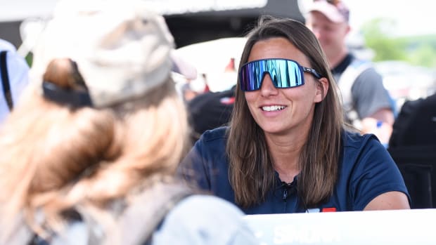 Simona De Silvestro greets a fan Friday at Road America. Photo courtesy IndyCar / James Black.