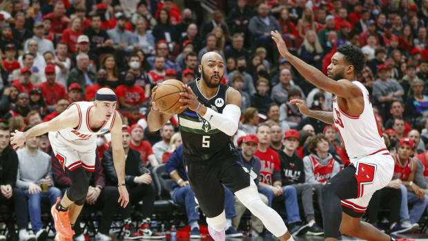 Apr 22, 2022; Chicago, Illinois, USA; Milwaukee Bucks guard Jevon Carter (5) drives to the basket against the Chicago Bulls during the first half of game three of the first round for the 2022 NBA playoffs at United Center.