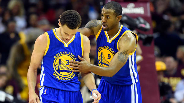 Warriors wing Andre Iguodala consoles Stephen Curry during the 2015 NBA Finals.