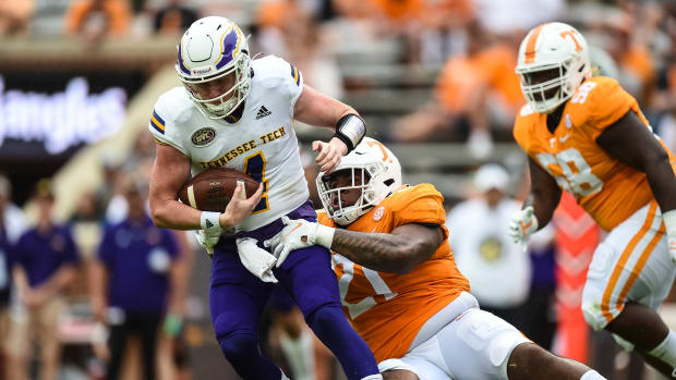 Sep 18, 2021; Knoxville, Tennessee, USA; Tennessee Tech Golden Eagles quarterback Drew Martin (4) is tackled by Tennessee Volunteers defensive lineman Omari Thomas (21) during the second half at Neyland Stadium.