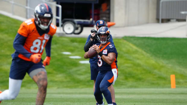 Denver Broncos quarterback Russell Wilson (3) drops back to pass during OTA workouts at the UC Health Training Center.