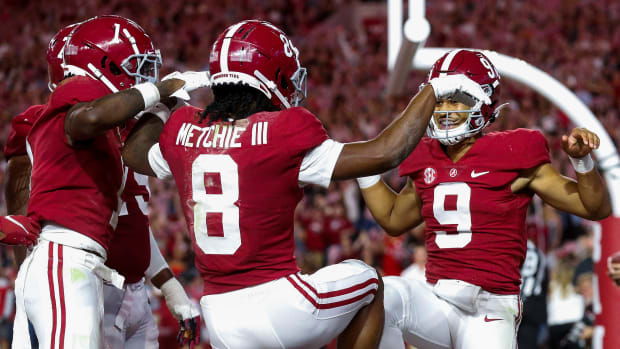 Oct 23, 2021; Tuscaloosa, Alabama, USA; Alabama Crimson Tide wide receiver Jameson Williams (1) and wide receiver John Metchie III (8) and quarterback Bryce Young (9) celebrate after a touchdown against the Tennessee Volunteers during the first half at Bryant-Denny Stadium. Mandatory Credit: Gary Cosby Jr.-USA TODAY Sports