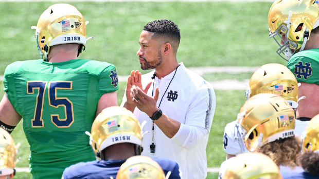 Notre Dame coach Marcus Freeman claps on the sideline