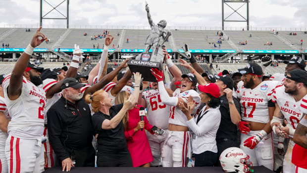Dec 28, 2021; Birmingham, Alabama, USA; Houston Cougars celebrate with the trophy after defeating the Auburn Tigers at the 2021 Birmingham Bowl at Protective Stadium.