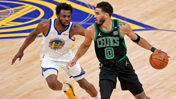 Celtics forward Jayson Tatum (0) handles the ball against Warriors forward Andrew Wiggins (22) during the first quarter in Game 5 of the 2022 NBA Finals.