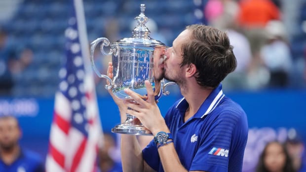 Russian tennis player Daniil Medvedev kisses the championship trophy after his match against Novak Djokovic in the men’s singles final of the 2021 U.S. Open.
