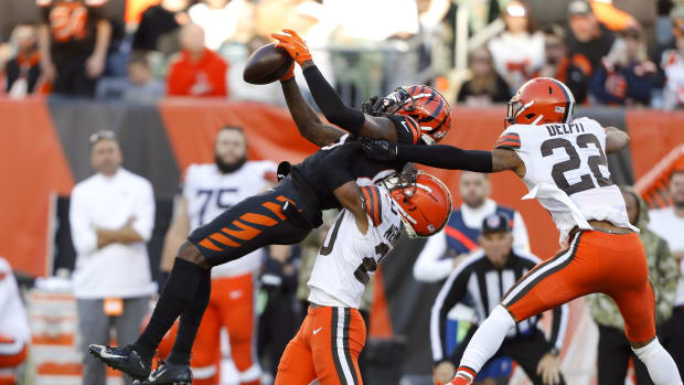 Nov 7, 2021; Cincinnati, Ohio, USA; Cincinnati Bengals wide receiver Tee Higgins (85) fights for the ball with Cleveland Browns defensive back Grant Delpit (22) and cornerback Greg Newsome II (bottom) during the fourth quarter at Paul Brown Stadium. Mandatory Credit: Joseph Maiorana-USA TODAY Sports