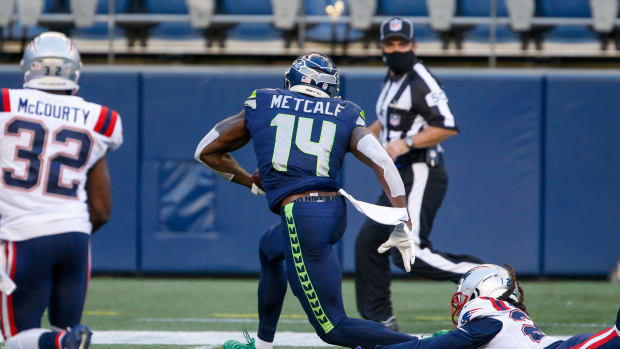 NFL: New England Patriots at Seattle Seahawks Sep 20, 2020; Seattle, Washington, USA; Seattle Seahawks wide receiver DK Metcalf (14) breaks a tackle against the New England Patriots for a touchdown catch during the second quarter at CenturyLink Field.