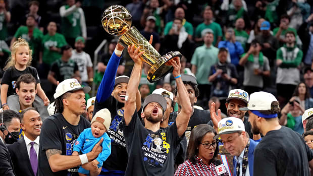 Golden State Warriors guard Stephen Curry (30) celebrates with the the Larry O'Brien Championship Trophy after the Golden State Warriors beat the Boston Celtics in game six of the 2022 NBA Finals to win the NBA Championship at TD Garden.