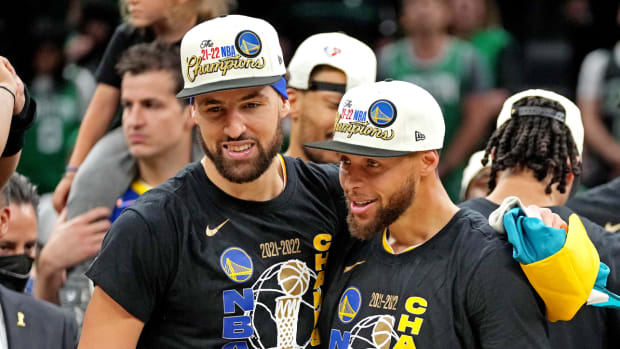 Golden State Warriors guard Stephen Curry (30) and guard Klay Thompson (11) celebrate after beating the Boston Celtics in game six of the 2022 NBA Finals to win the NBA Championship.