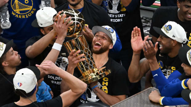 Golden State Warriors guard Stephen Curry (30) holds up the Larry O'Brien Trophy after defeating the Boston Celtics in game six of the 2022 NBA Finals.
