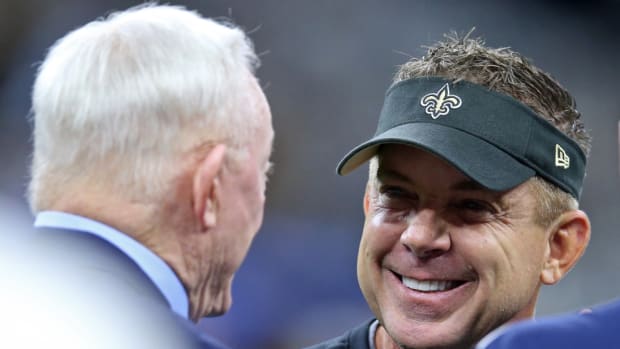 New Orleans Saints head coach Sean Payton talks to Dallas Cowboys owner Jerry Jones.