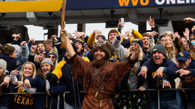 Mountaineers fans throw the horns down during the game against West Virginia on Saturday, Nov. 20, 2021