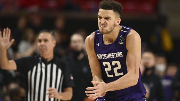 Pete Nance claps his hands in excitement for Northwestern basketball.
