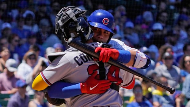 Chicago Cubs catcher Willson Contreras (40) hugs his brother Atlanta Braves catcher William Contreras (24) as he comes to bat during the first inning at Wrigley Field.