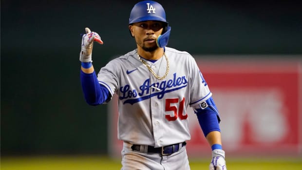 Los Angeles Dodgers’ Mookie Betts (50) motions to his dugout after a base hit against the Arizona Diamondbacks during the sixth inning of a baseball game, Thursday, May 26, 2022, in Phoenix. (AP Photo/Matt York)