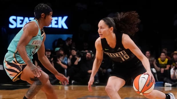 Sue Bird dribbles against the Liberty’s Crystal Dangerfield.