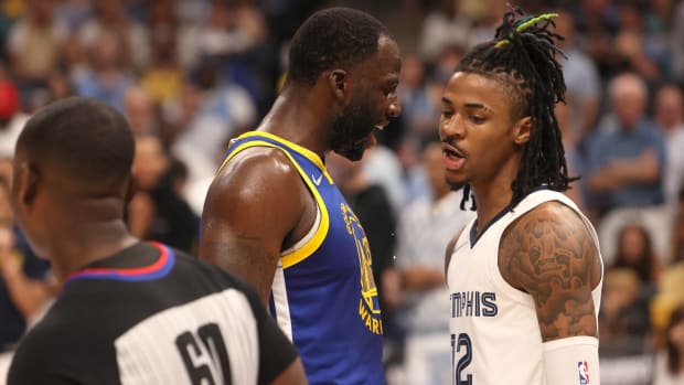 Draymond Green and Ja Morant argue in front of a ref in the Warriors-Grizzlies playoff series.