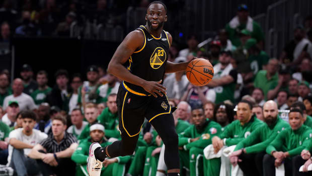 Warriors forward Draymond Green (23) dribbles the ball up the court against the Boston Celtics during the first quarter of Game 4 of the 2022 NBA Finals.