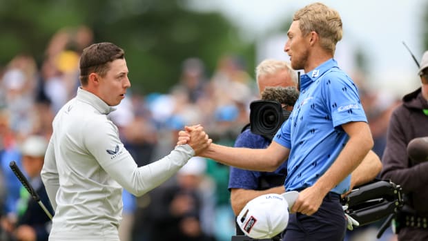 Will Zalatoris, right, shakes hands with Matt Fitzpatrick on the 18th green during the final round of the U.S. Open golf tournament