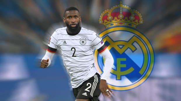 Antonio Rudiger pictured in Germany kit in front of a giant Real Madrid crest