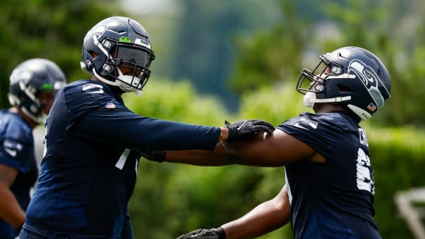 Seattle Seahawks tackle Greg Eiland (75, left) and offensive tackle Charles Cross (67, right) participate in a drill during minicamp practice at the Virginia Mason Athletic Center Field.