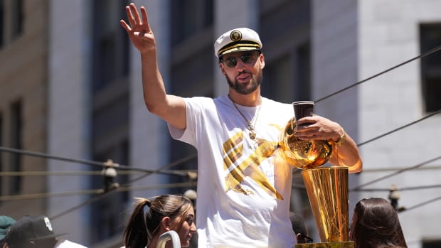 Warriors guard Klay Thompson gestures during their championship parade in downtown San Francisco.