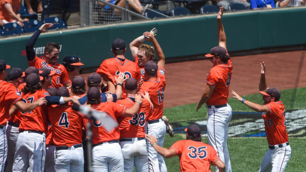 Virginia Cavaliers catcher Logan Michaels (12) celebrates with outfielder Chris Newell (9) after hitting a home run in the third inning against the Tennessee Volunteers at TD Ameritrade Park.