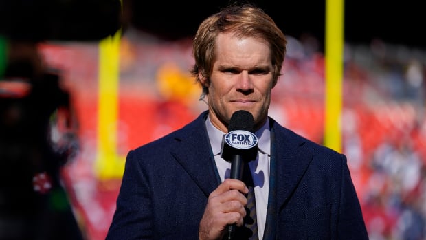 Greg Olsen with a Fox Sports microphone on the sidelines.