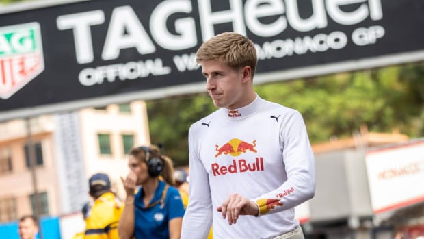 Red Bull junior driver Juri Vips looks on while walking around the track at the Monaco Grand Prix.