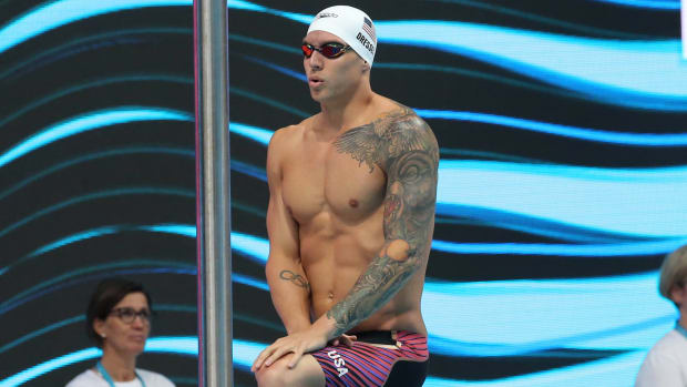American swimmer Caeleb Dressel stands on the blocks before an event.