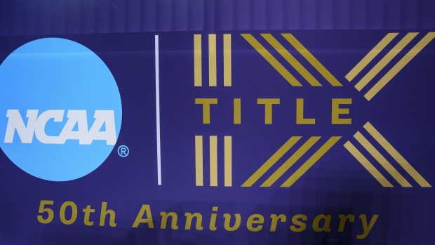 A Title IX 50th anniversary banner hangs at the Men's Basketball Final Four in New Orleans.