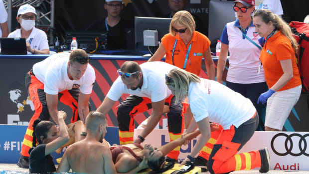 Paramedics help Anita Alvarez out of the pool after the swimmer fainted in the middle of a performance.