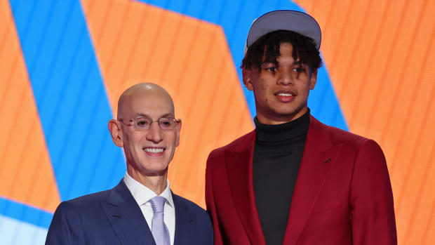 Ousmane Dieng shakes hands with NBA commissioner Adam Silver after being selected as the number eleven overall pick.